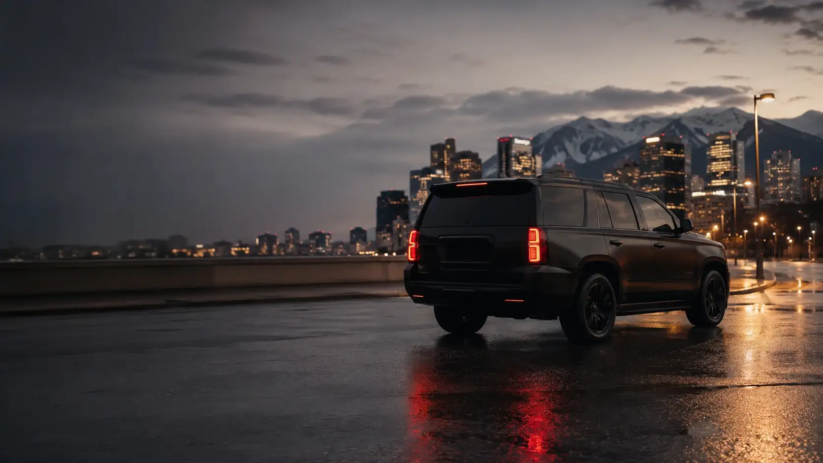 A black chauffeured SUV on a wet downtown Denver street at dusk, with the Front Range beyond the skyline.